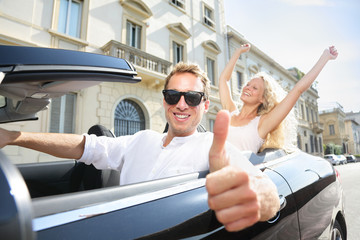 Wall Mural - Car driver happy giving thumbs up - driving couple