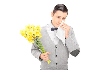 Wall Mural - Sad man holding bunch of flowers and crying