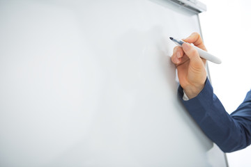 Wall Mural - Closeup on business woman writing on flipchart