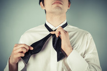 Young Man Tying A Bow Tie