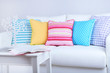 White sofa with colorful pillows in room