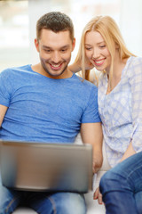 Canvas Print - smiling happy couple with laptop at home