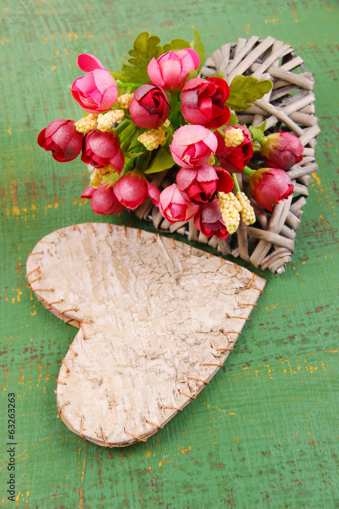 Decorative hearts and flowers  on color wooden background