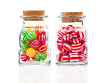 Two Filled Glass Candy Jars Isolated Over White Background