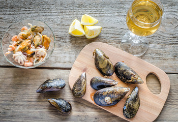 Sticker - Mussels with a glass of white wine on the wooden table