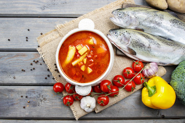 Wall Mural - Bowl of tomato soup on wooden table