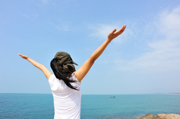 Wall Mural - cheering woman open arms at  seaside