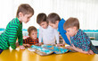 © spass - Cute preschoolers plaing game on table