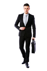 Wall Mural - Handsome businessman walking with laptop bag