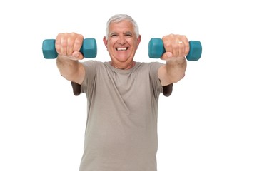 Portrait of a happy senior man exercising with dumbbells