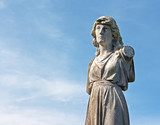 Fototapeta  - A Female weathered statue in ancient graveyard