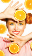 Beauty model girl takes juicy oranges. Freckles