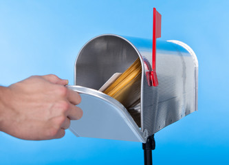 Wall Mural - Man opening his mailbox to remove mail