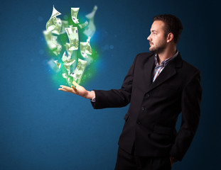 Wall Mural - Glowing money in the hand of a businessman