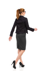 Walking woman, rear angle view.