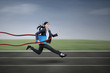 © Creativa Images - Businesswoman winning a business race
