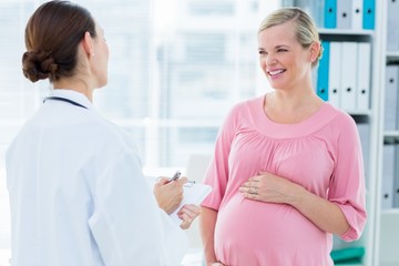 Pregnant woman discussing with female doctor