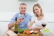 © lightwavemedia - Loving couple with wine glasses in kitchen