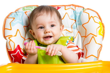 Wall Mural - smiling baby boy with spoon