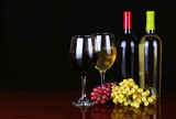 Fototapeta Panele - Wine Bottles and Glasses of Wine over black background.