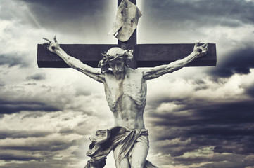 Poster - Crucifixion. Christian cross with Jesus Christ statue over storm