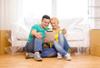 © Syda Productions - smiling couple with tablet pc in new home