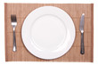 © asajdler - White plate on a bamboo mat