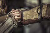 Fototapeta Konie - Nailed hand on wooden cross. Jesus Christ crucifixion
