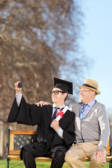 Wall Mural - Student and his proud father taking selfie in park