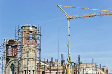 New church construction with crane over sky