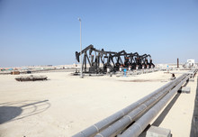 Black Oil Pump Jacks In The Desert Of Bahrain, Middle East