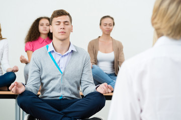 Wall Mural - group of young people meditating