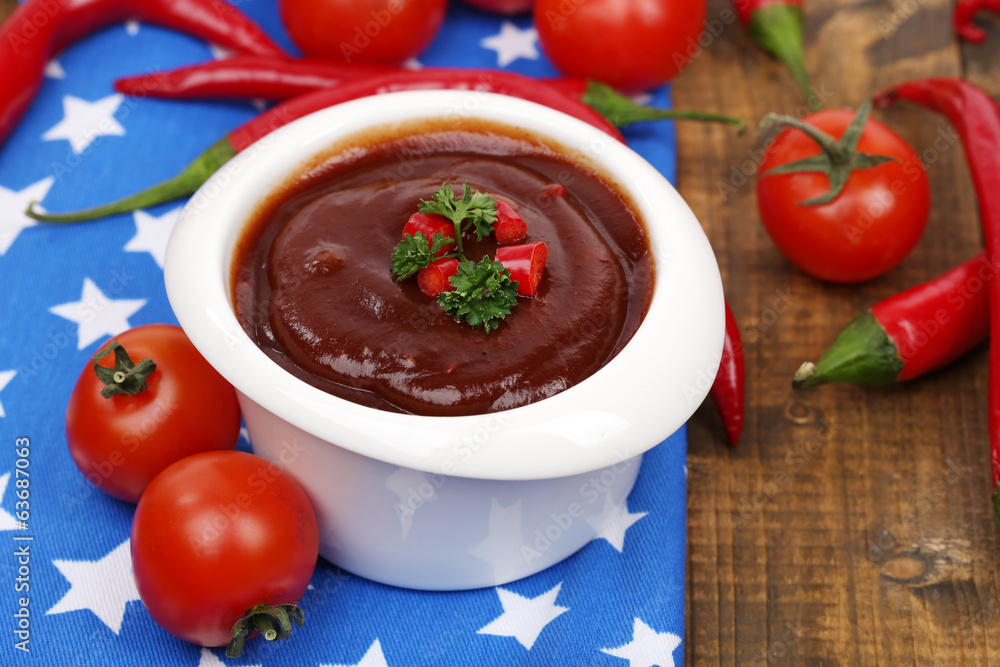 Tomato sauce in bowl on wooden table close-up