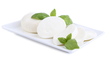 Wall Mural - Tasty mozzarella cheese with basil on plate isolated on white