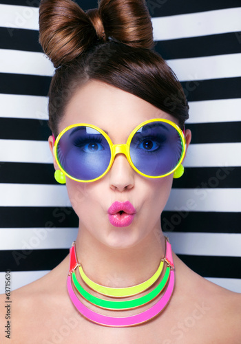 Fototapeta dla dzieci Attractive surprised young woman wearing sunglasse