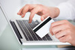 © Andrey Popov - Man Shopping With Credit Card And Laptop