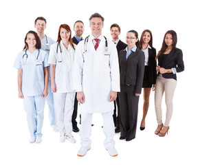 Wall Mural - Doctor standing in front of his team