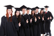 © Andrey Popov - Graduate students standing in row showing thumbs up