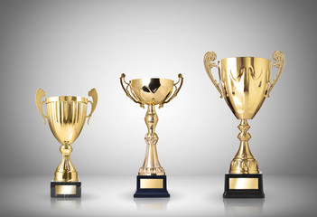 golden trophies on gray background