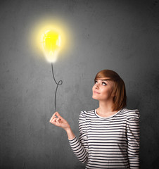 Wall Mural - Woman holding a lightbulb balloon