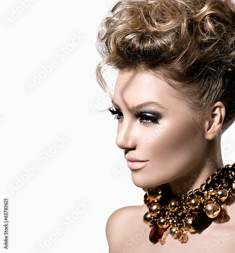 Fototapeta na wymiar Beautiful model girl with perfect fashion makeup and hairstyle