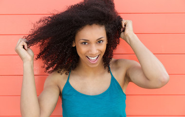 Wall Mural - Friendly young woman smiling outdoors