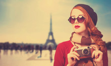 Redhead Girl With Camera On Paris Background.