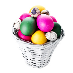 Wall Mural - Colorful easter eggs in basket isolated on white background clos