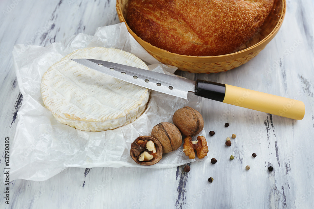 Tasty Italian cheese and bread on wooden table