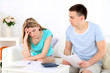 © Africa Studio - Young couple calculating finance at desk,