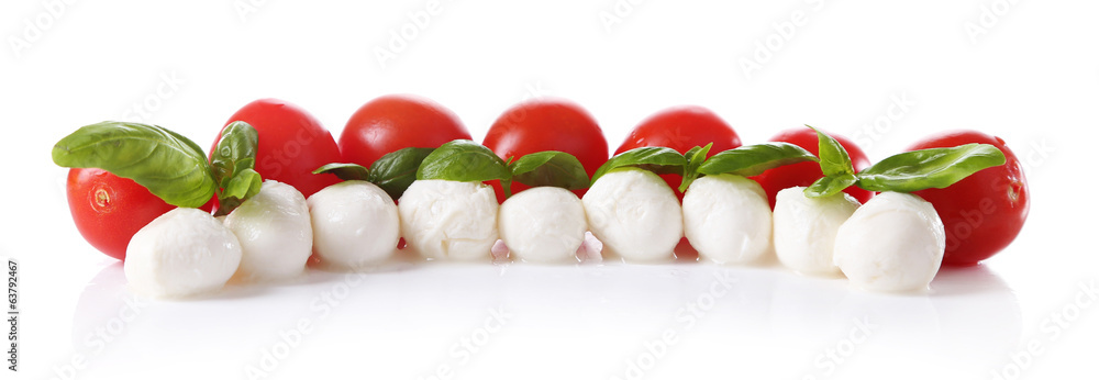 Tasty mozzarella cheese balls with basil and red tomatoes,