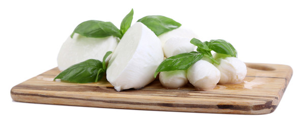 Canvas Print - Tasty mozzarella with basil on wooden board isolated on white