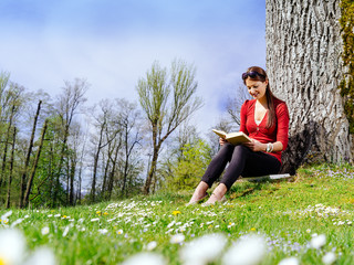 Young woman reading outdoors