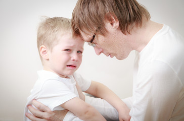 father comforting son in tears